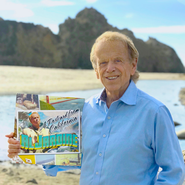 Al Jardine shows off the vinyl version of his album A Postcard from California